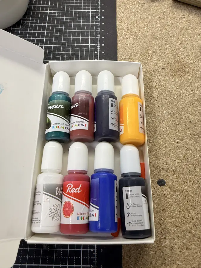 A box of eight small bottles of silicone colour.